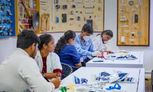 Students engaged in a hands-on workshop session, working with various tools and equipment at a lab